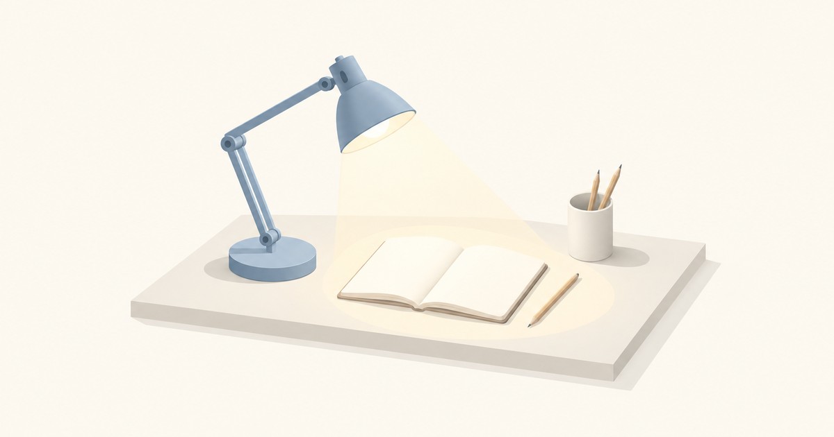 A blue adjustable desk lamp casts a warm cone of light onto an open blank notebook and pencil on a pale desk, beside a cup holding pencils.